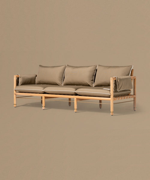 Beige sofa with brown cushions on a matching beige background