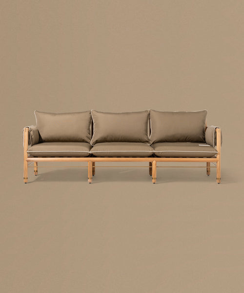 Brown sofa with wooden frame on a beige background