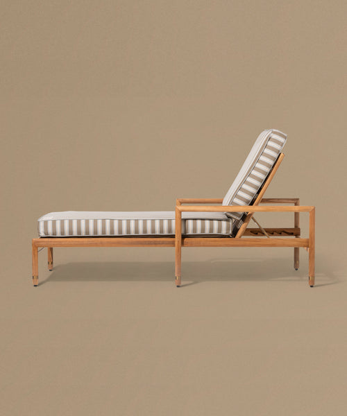 Wooden lounge chair with striped cushion on a beige background
