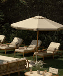 Beige lounge chair with white cushions in the garden