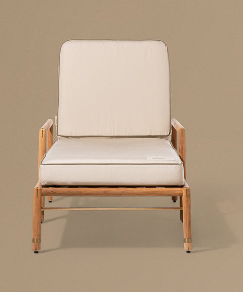 Beige lounge chair with white cushions on a beige background