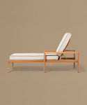 Beige lounge chair with white cushions on a beige background
