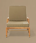 Lounge chair with green cushion on a beige background