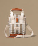 Stripped bag with leather accents on a beige background
