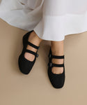 The Wren Flat is a pair of black Mary Jane shoes with double straps and a rounded square toe.