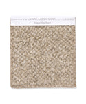 A square swatch of textured, looped beige wool with frayed edges, labeled “Fabric Swatch Natural Wool Boucle” on a white strip—ideal for Jenni Kayne Furniture or an upholstered bench.