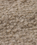 Close-up of Fabric Swatch Natural Wool Boucle, showcasing tightly packed, curly beige fibers in a loop-pile texture, similar to the cozy and soft finish seen on Jenni Kayne Furniture.