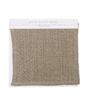 A square Fabric Swatch Taupe Linen with a coarse, textured weave is displayed on a white card labeled jenni kayne home—a perfect reference for selecting dining chair upholstery.