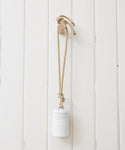 An Oak Wall Hook holds a thick rope tied to a white ceramic weight, mounted on a white paneled wall.