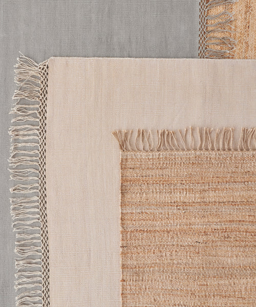 A close-up of the Arrowhead Jute Rug highlights its intricate handwoven texture and expert craftsmanship.