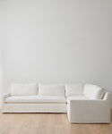 The Harbor Sectional, upholstered in plush Belgian flax linen, brings timeless elegance to any room with its refined white design.