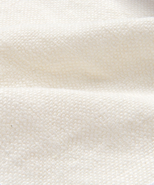 Close-up of the Fabric Swatch Ivory Linen, showcasing a textured Belgian flax linen in off-white with a subtle woven pattern and gentle horizontal folds.