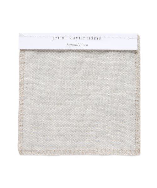 A square swatch of Fabric Swatch Natural Linen with stitched edges is shown on a white background, labeled jenni kayne home: Natural Linen, reflecting the refined style of Jenni Kayne furniture and Belgian flax linen.