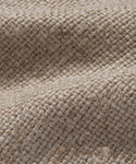 Close-up of the Miramar Chaise Slipcovers textured beige burlap fabric, highlighting its coarse woven fibers, small knots, and natural folds—reminiscent of the organic texture found in flax linen.