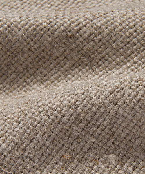 Close-up of the Fabric Swatch Flax Linen in natural beige, highlighting its grid-like pattern, visible fibers, and gentle folds—ideal for upholstery projects such as sofas.