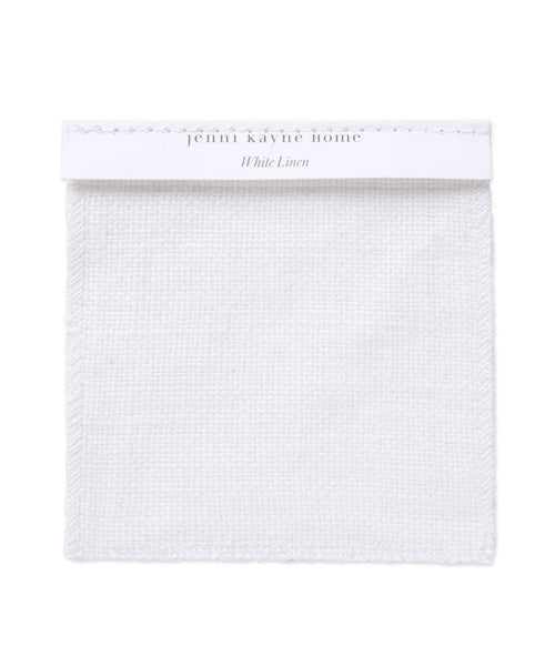 A square Fabric Swatch White Linen with a textured weave, attached to a white label reading jenni kayne home White Linen in light gray—ideal for planning your Miramar Sofa upholstery.