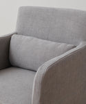 A close-up of the Sunset Dining Arm Chair Slipcover in light gray ash linen, featuring clean lines and a matching rectangular cushion for a modern, comfortable look.