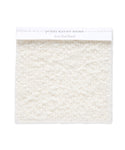 A square Fabric Swatch Ivory Wool Boucle with a soft, textured, looped surface and a white label reading Jenni Kayne Home Ivory Wool Boucle, perfect for Jenni Kayne Furniture or an upholstered bench.